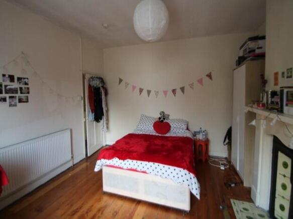 A bright and cozy master bedroom featuring a la...