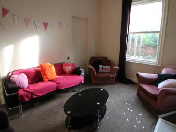 A bright and welcoming living room featuring co...