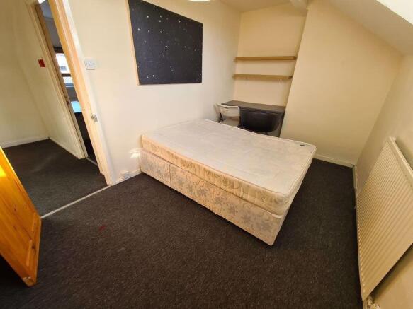 A spacious, well-maintained bedroom featuring a...