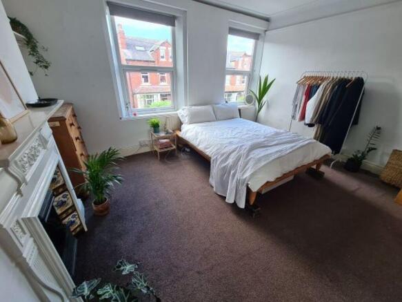 A bright and inviting master bedroom featuring ...