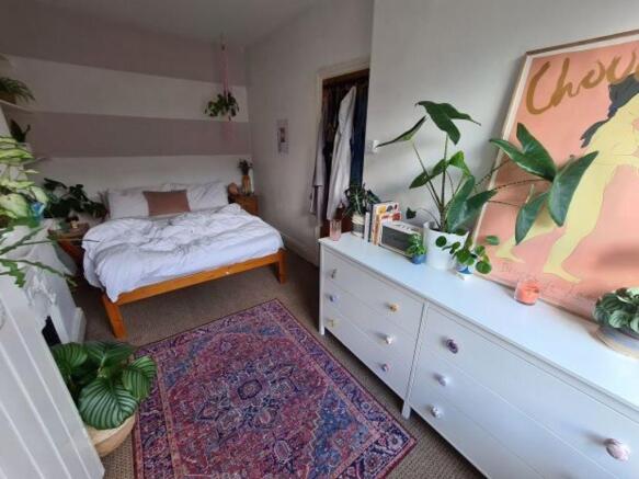 A spacious and well-lit master bedroom featurin...