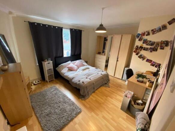 A cozy and well-maintained master bedroom featu...