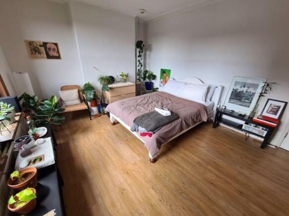 Bright and spacious master bedroom featuring a ...