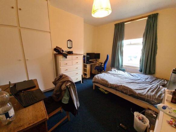 A cozy bedroom with natural light streaming in ...