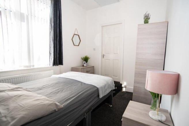 A neatly presented bedroom with a comfortable s...