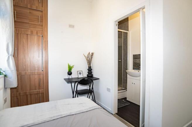 A clean and modern bathroom with a shower, smal...