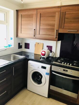 A well-maintained kitchen featuring wooden uppe...