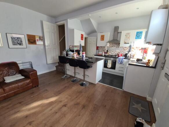 A modern, open-plan kitchen featuring a wooden ...