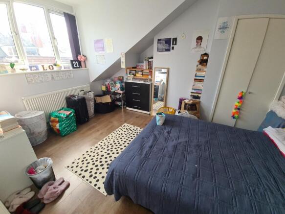 Bright and cozy master bedroom featuring a larg...