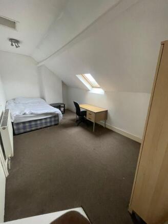 A spacious, bright living room with a skylight ...