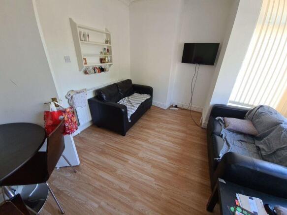 A well-lit, modern living room with two comfort...