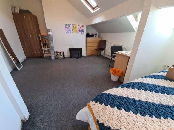 A spacious, well-lit living room featuring comf...