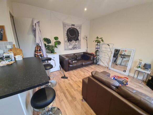 A spacious and well-lit contemporary living roo...