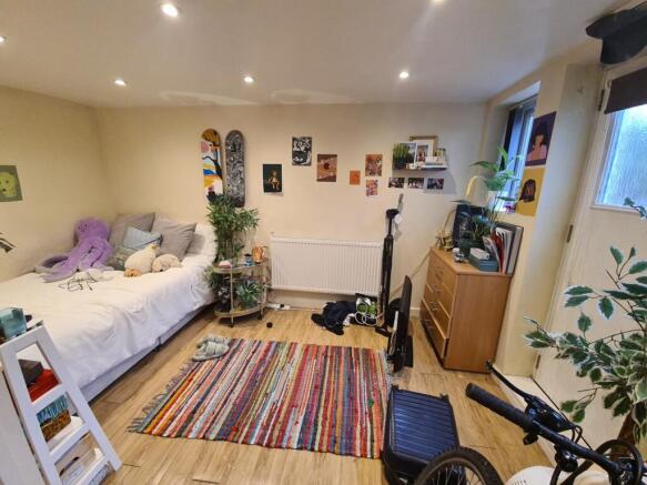 A well-lit, cozy living room with comfortable s...