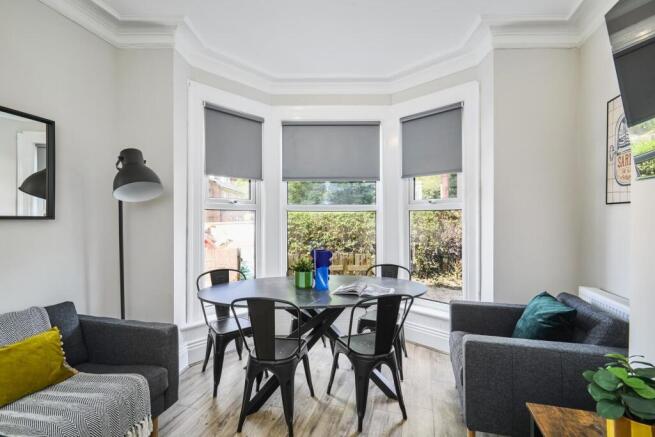 Bright and welcoming living room with large bay...