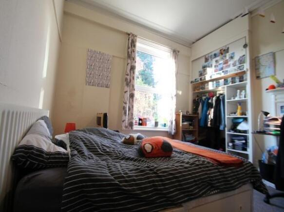 A cozy bedroom featuring a double bed with a st...