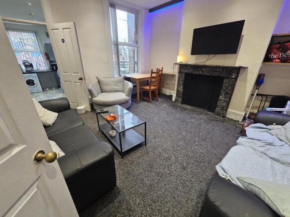 A modern, well-lit living room featuring a larg...