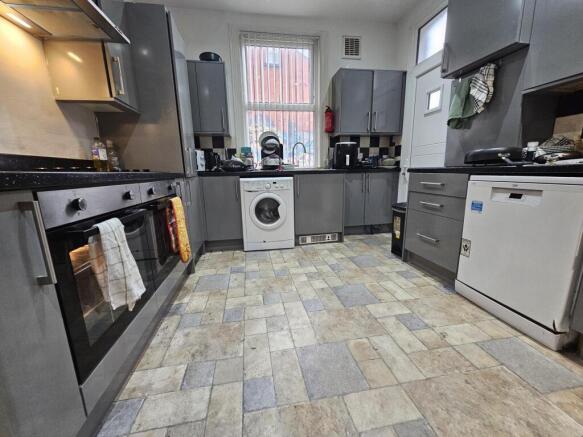 A spacious and well-maintained kitchen with mod...