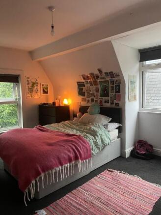 Cosy double bedroom with a comfortable bed, lay...