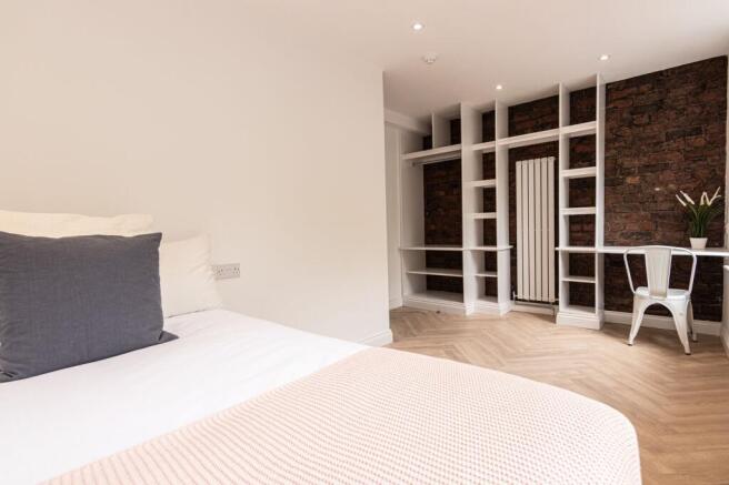 Bright and modern bedroom featuring a cozy doub...