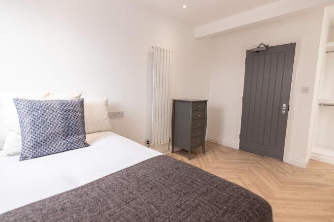 A bright and welcoming double bedroom featuring...