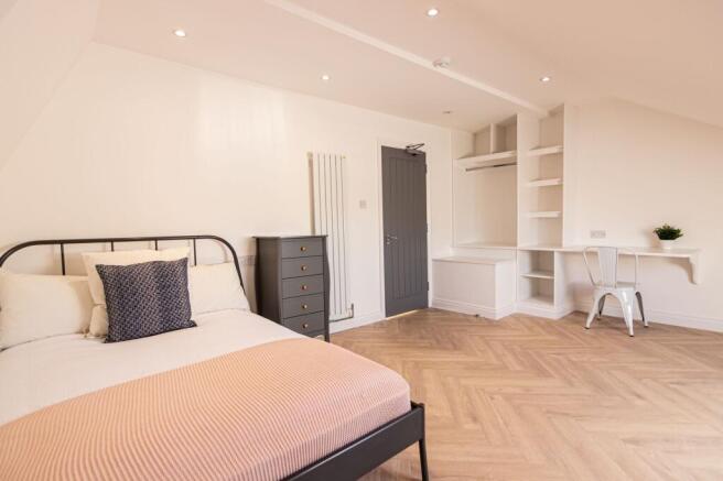 A bright and welcoming bedroom featuring a mode...