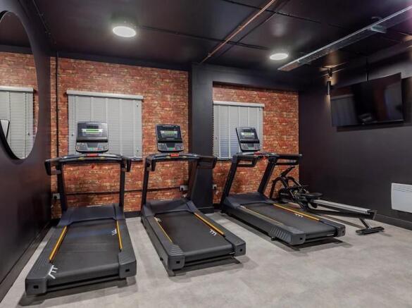 A well-maintained gym area equipped with treadm...