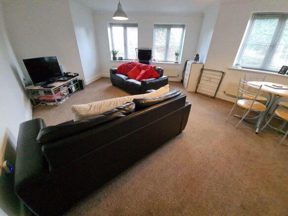 Bright and spacious living room featuring two l...