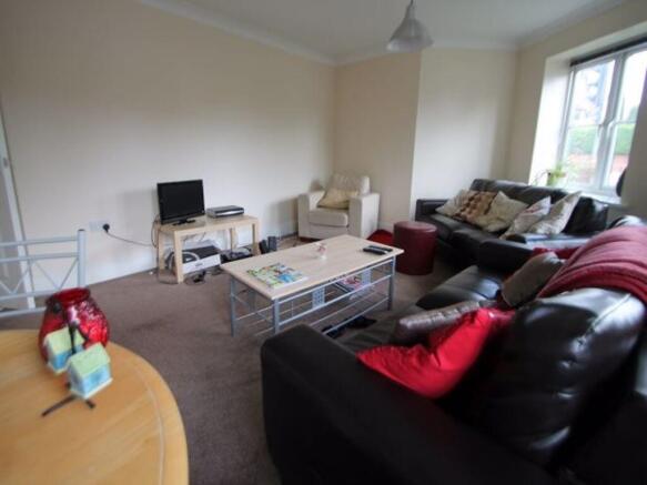Spacious and bright living room with comfortabl...