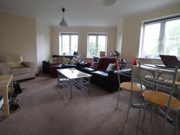 A spacious and inviting living room with ample ...
