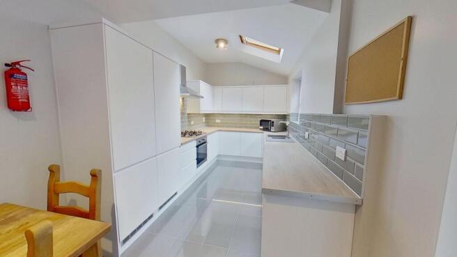 Modern, bright kitchen with sleek white cabinet...