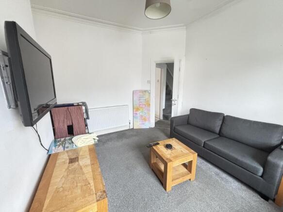 Bright, neutrally decorated living room with a ...