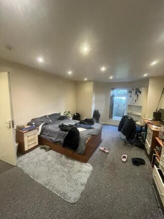 Spacious and well-lit master bedroom featuring ...