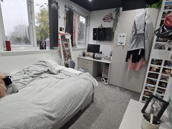 A cozy bedroom featuring a double bed, a large ...