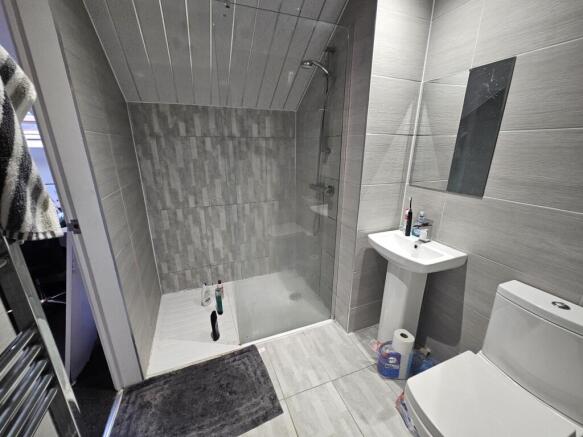 A modern and clean bathroom featuring light gre...