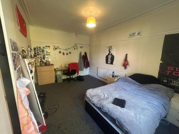 A comfortable and well-maintained bedroom featu...