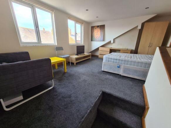 Spacious and well-lit master bedroom featuring ...