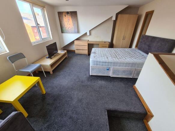 Bright and spacious bedroom featuring a large d...