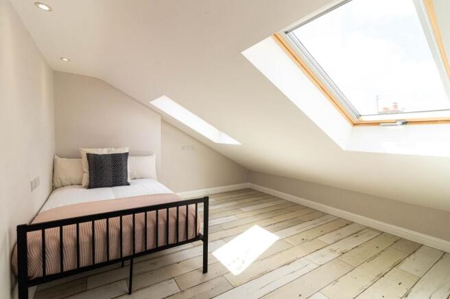 Bright and airy bedroom with large skylight win...