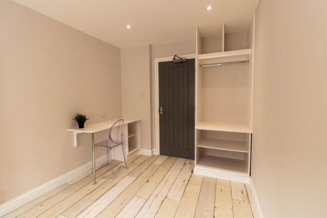 Bright, freshly decorated bedroom with pale woo...