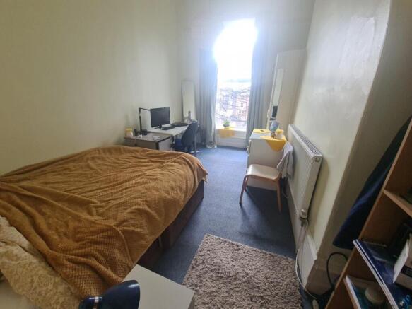 Cozy single bedroom with a comfortable bed, a d...