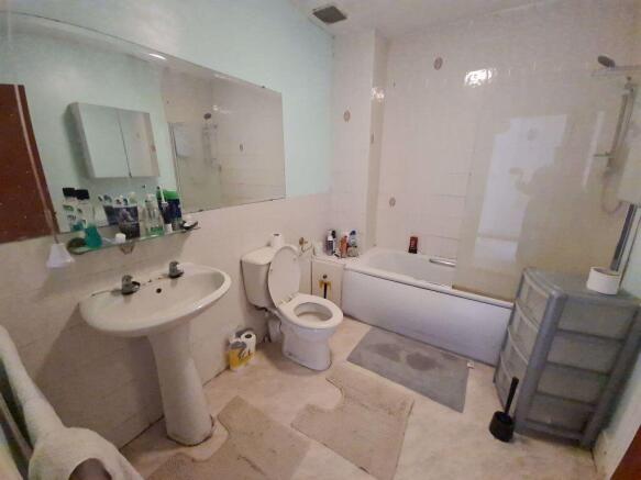 A bright and well-maintained bathroom suite fea...