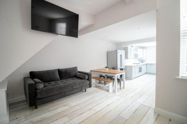 A modern, spacious living room with a large fla...