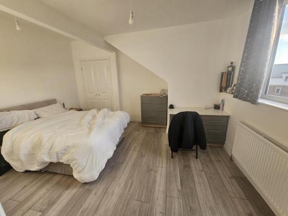 Bright and spacious master bedroom featuring a ...