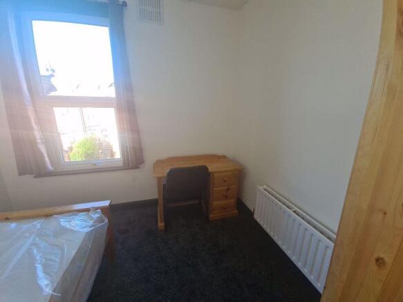 A cozy bedroom featuring a window that allows n...