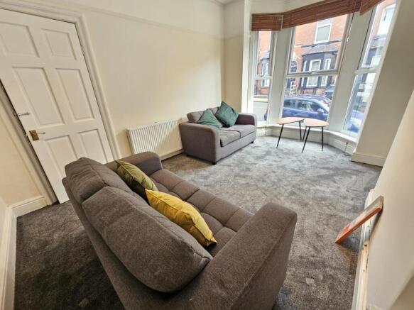 A bright and welcoming living room with comfort...