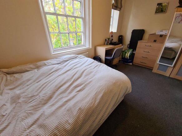 A cozy double bedroom featuring a comfortable d...