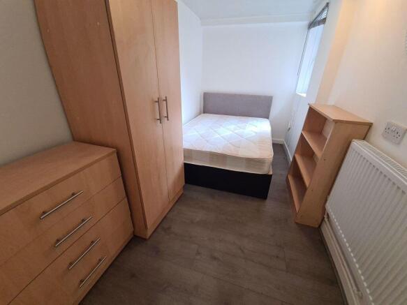 A neat and functional student bedroom featuring...