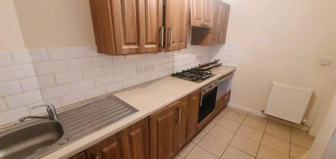 A modern kitchen with wooden cabinets, a built-...