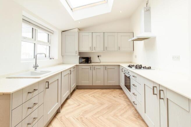 Bright and airy kitchen featuring ample counter...